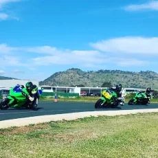 Motorcycle riders warming up on the track during a pre-event lap at MVTC